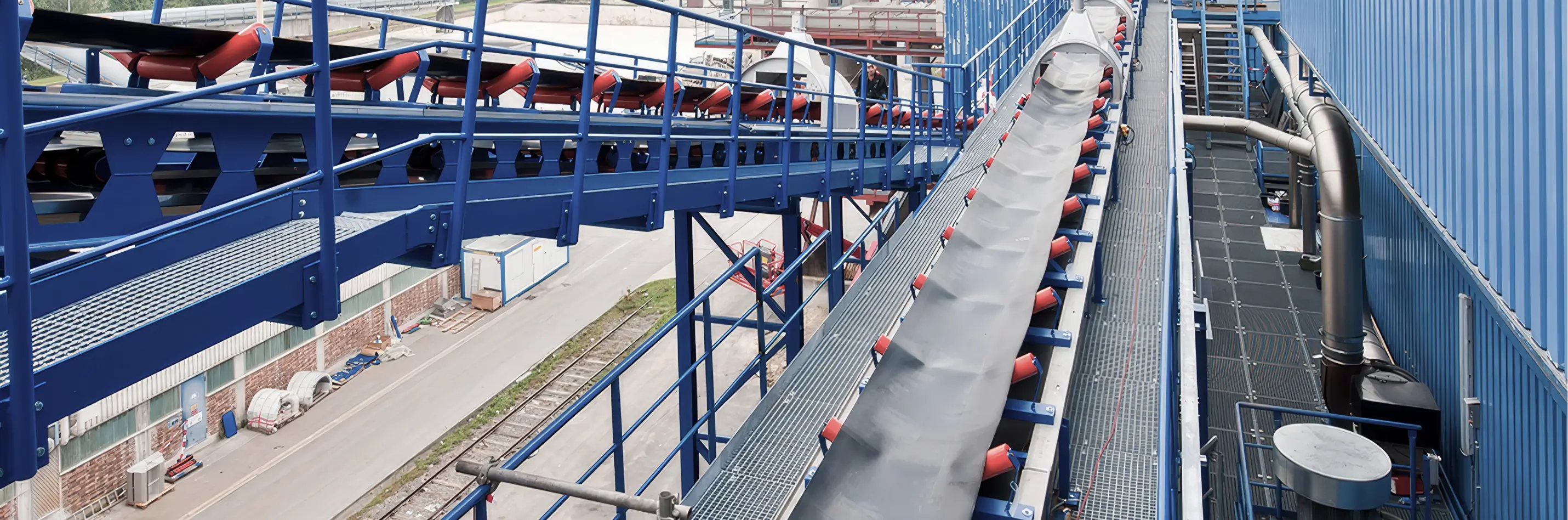 Moderne Industrieanlage mit blauen Förderbändern und technischen Einrichtungen.