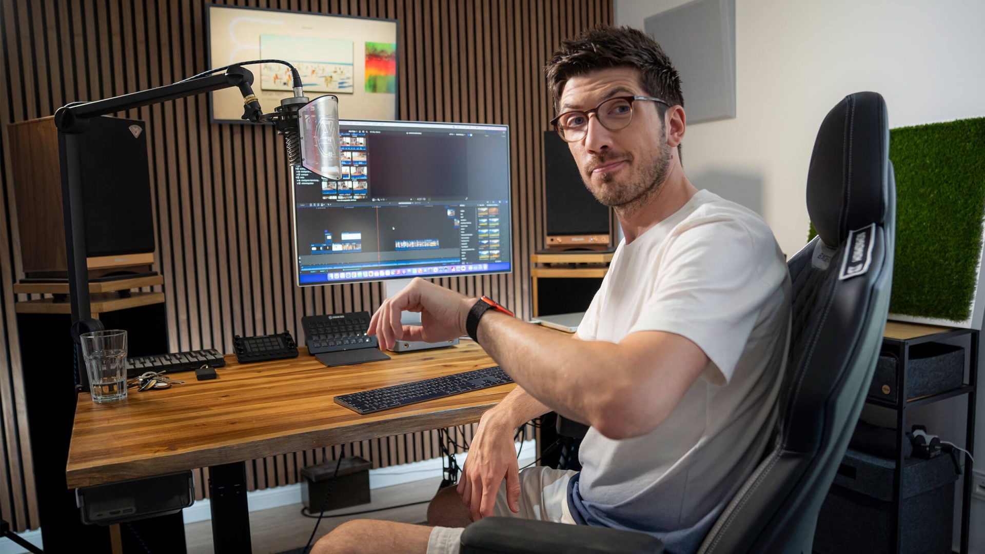Video Creator AlexiBexi sitzt vor seinem Computer und lächelt in die Kamera.